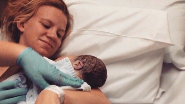 The 10 questions to ask on your hospital tour mom holding newborn baby in a hospital bed