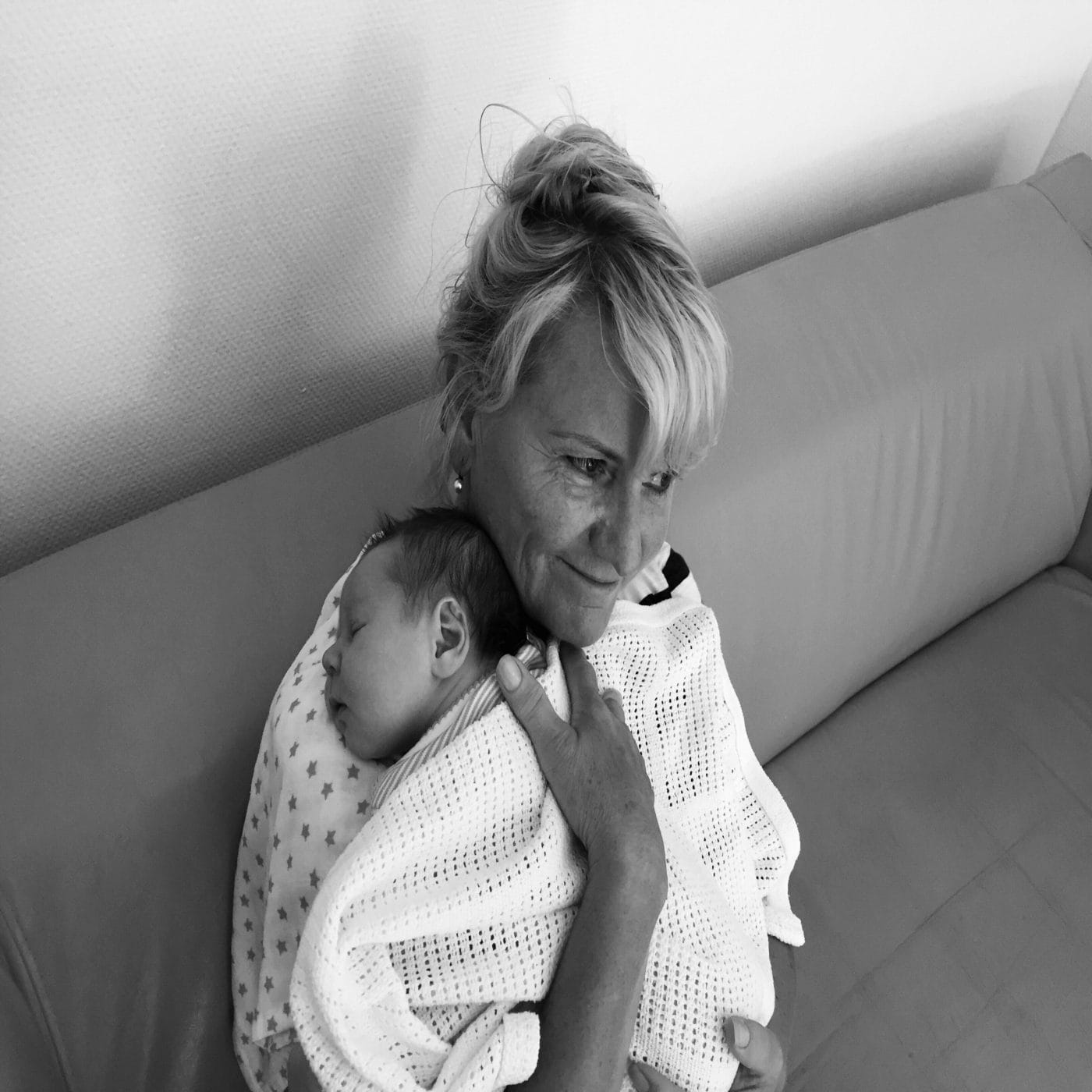 I finally see you, mom—all the love, sacrifice and selflessness grandma holding a baby to her chest