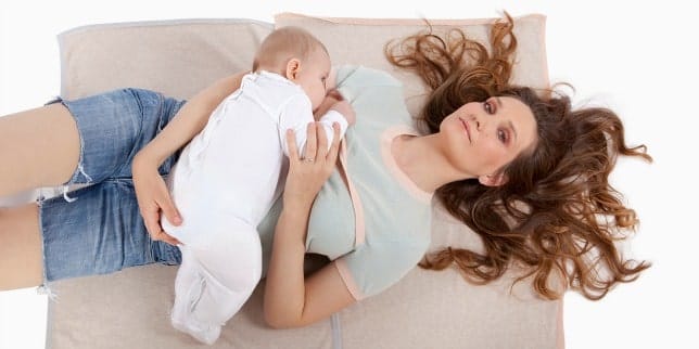Thinking About Breastfeeding? mom with baby sleeping on top of her