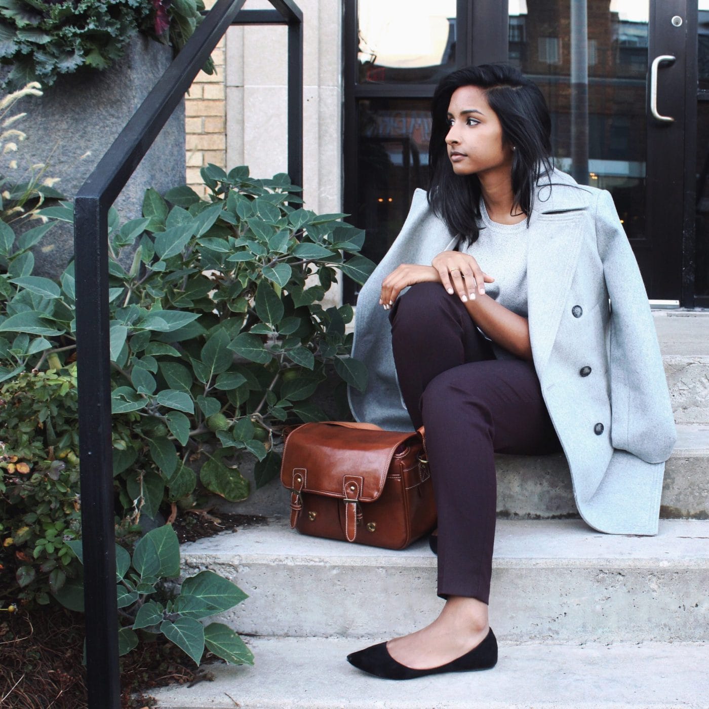 To my young, corporate mom self: You are enough Woman sitting outside on stairs