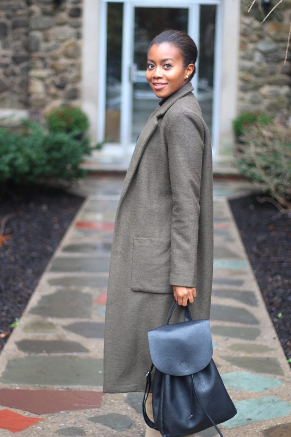 Productive + focused: Why mothers are rock star employees Woman wearing a coat and holding a briefcase