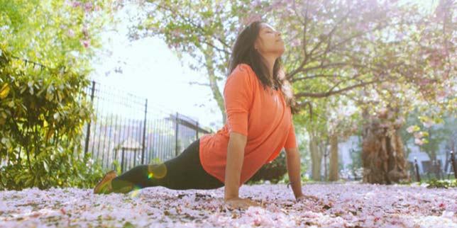 Yoga poses to help you conceive woman doing yoga in the park