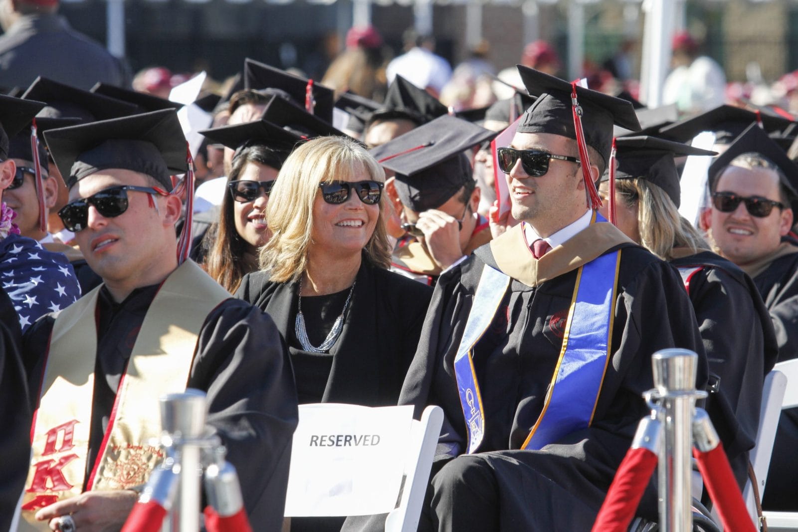 Master of motherhood: Mom receives honorary MBA alongside quadriplegic son