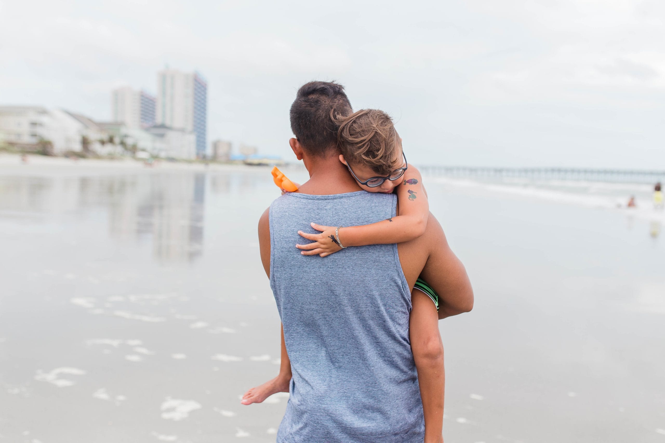 49 phrases to calm an anxious child dad holding daughter while walking on the beach