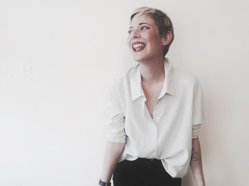 I was scared working would hurt my kids, but it actually saved us working mom: woman in white button down shirt laughing