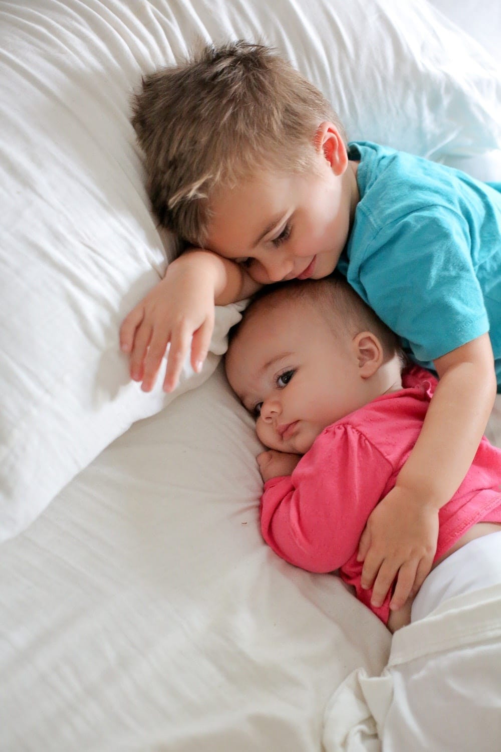 10 secrets for raising a kind and compassionate child older sibling snuggling baby