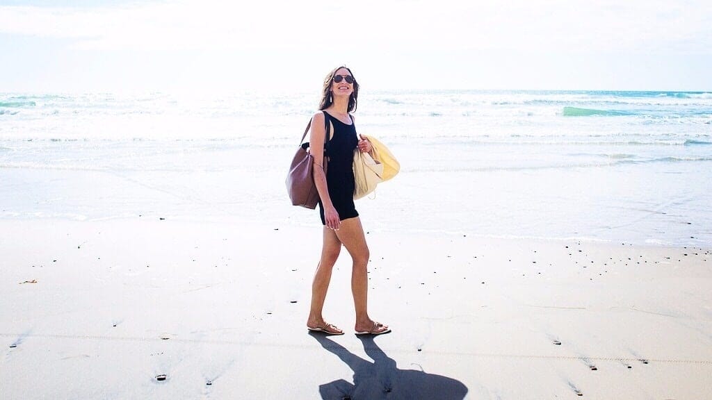 The one thing moms need most this summer: A BREAK ☀️ woman walking on beach