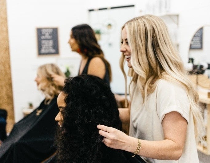 Micro interactions increase life satisfaction—so go ahead and talk to strangers woman sitting in a salon