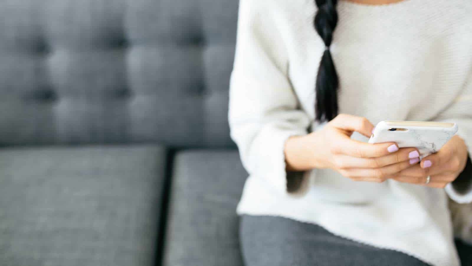 Text messages for parents actually help keep newborns safer, study finds woman playing on phone