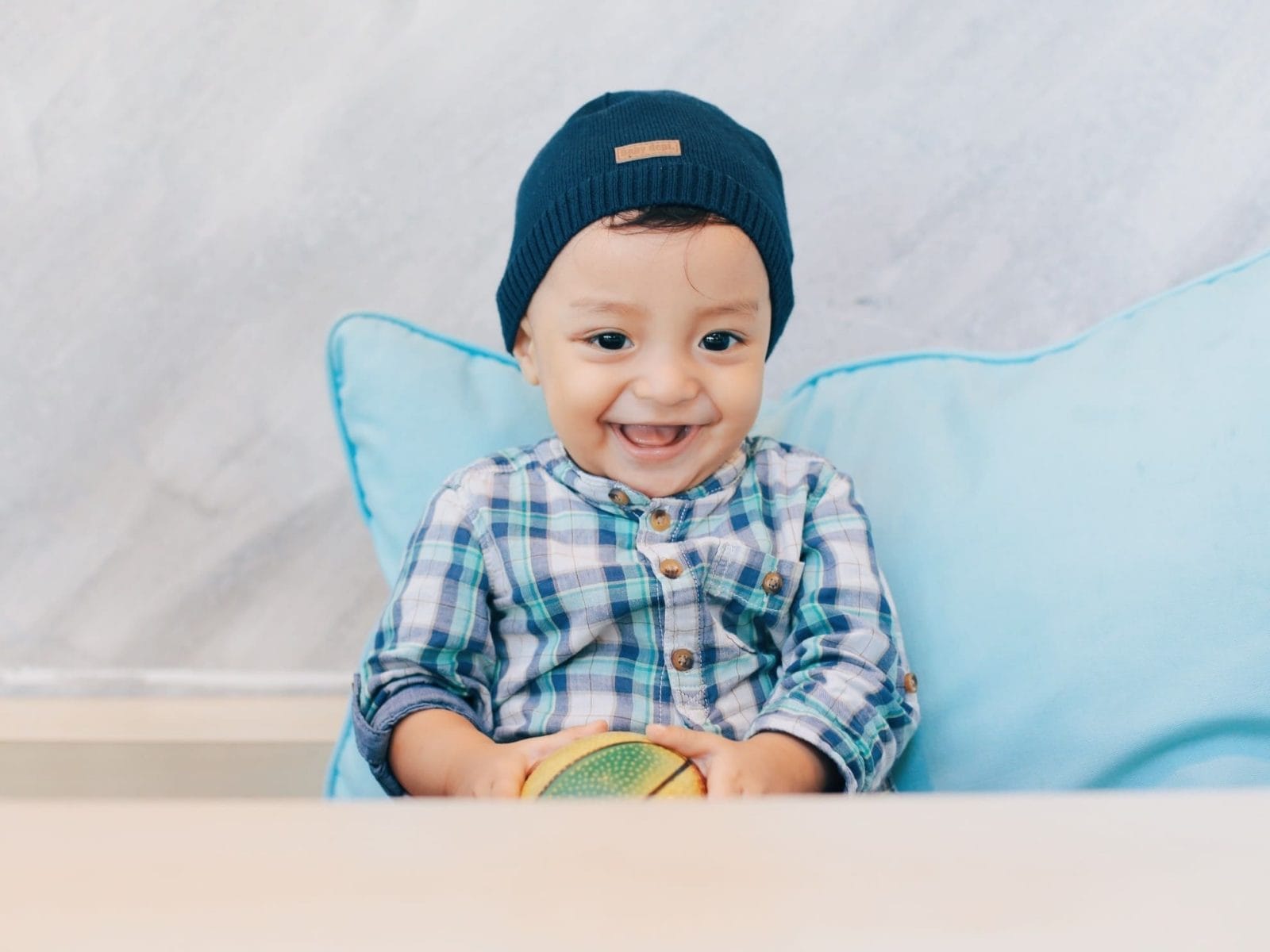 Toddler tantrums are pleas for control: How to help your child feel heard—not rewarded little boy giggling in a chair