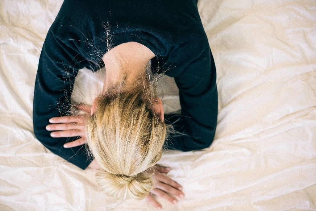 The mental load of motherhood is what I didn’t fully expect woman with her head in her hands