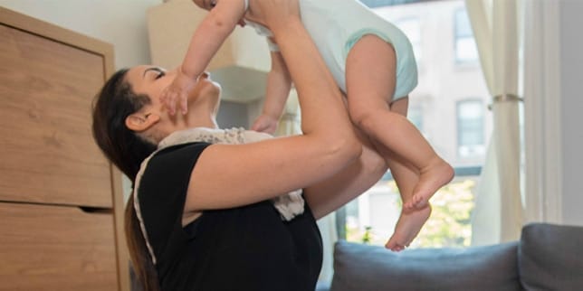 How to go back to work without weaning Woman holding toddler up