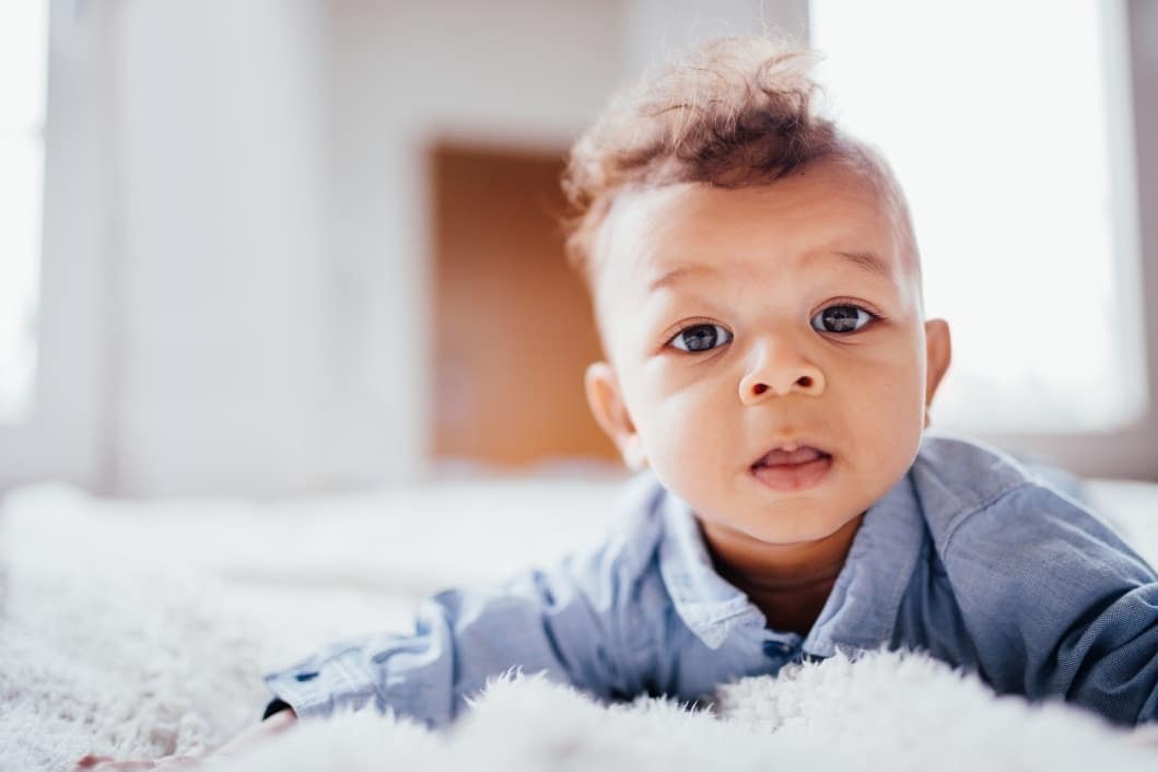 How one classic childhood game actually benefits young babies’ brains baby laying on his tummy