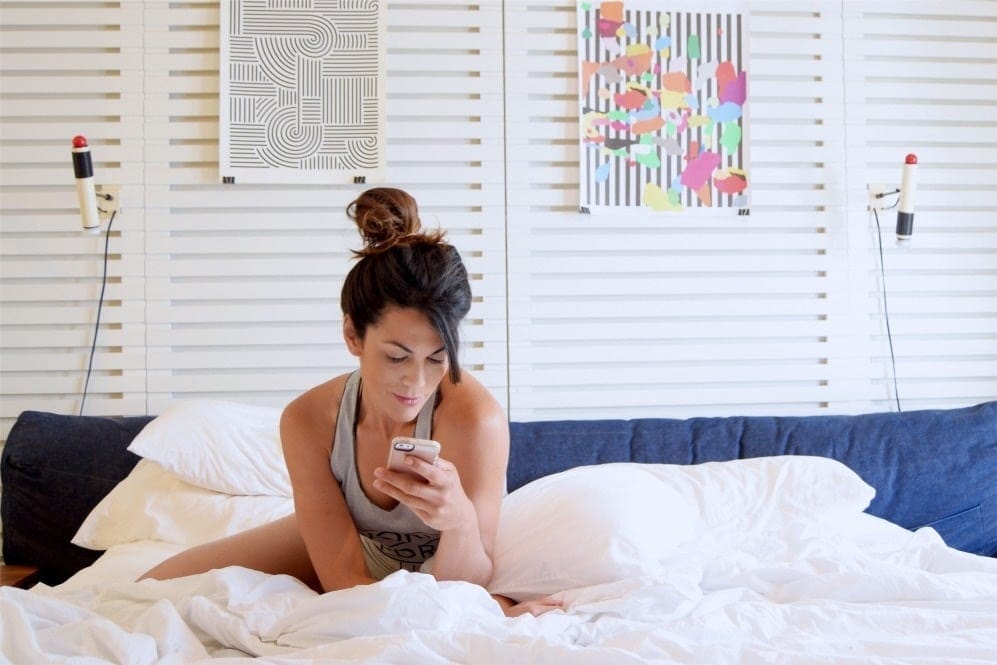Social media is her highlight reel—not real life mom scrolling social media on her phone
