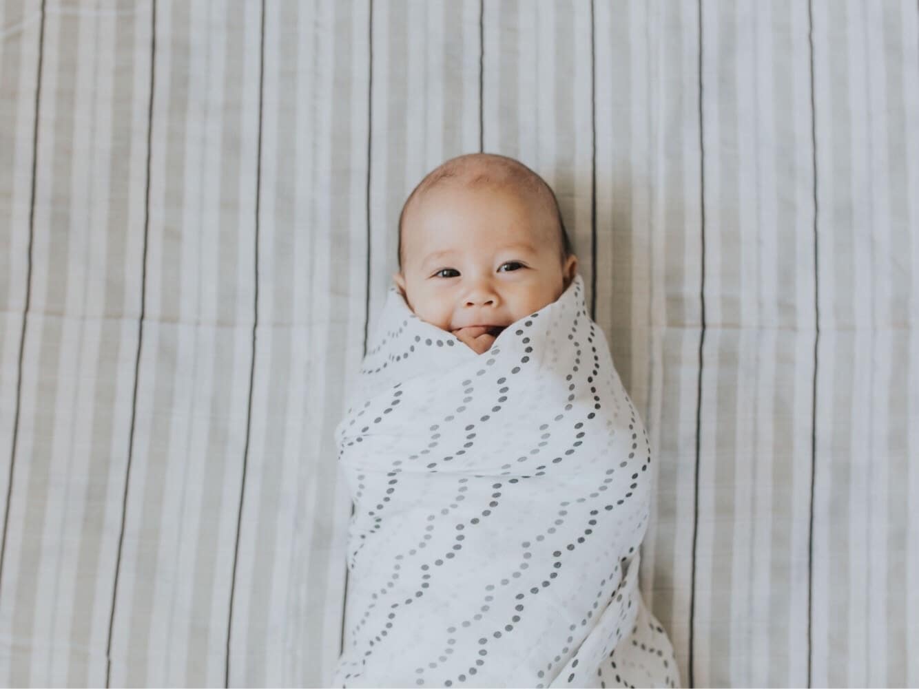 This expert wants you to know: Sleep regressions aren’t real baby swaddled in a blanket