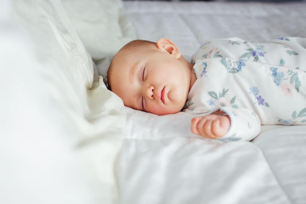 This expert wants you to know: There’s no wrong way to sleep train baby sleeping in a bed
