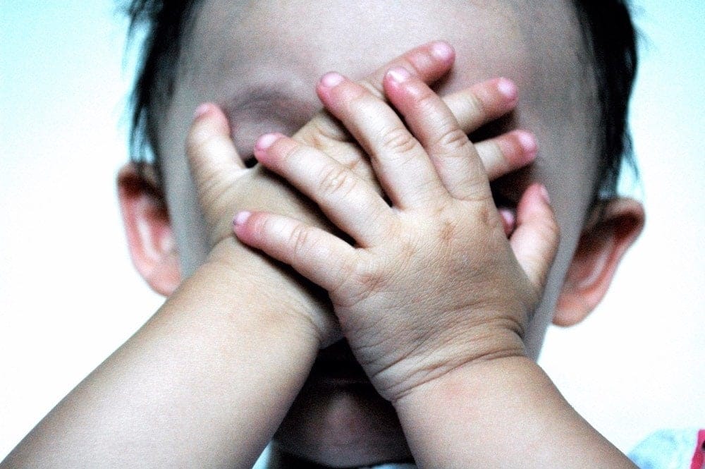Why I’m not rescuing my kids from failure toddler with hands over face