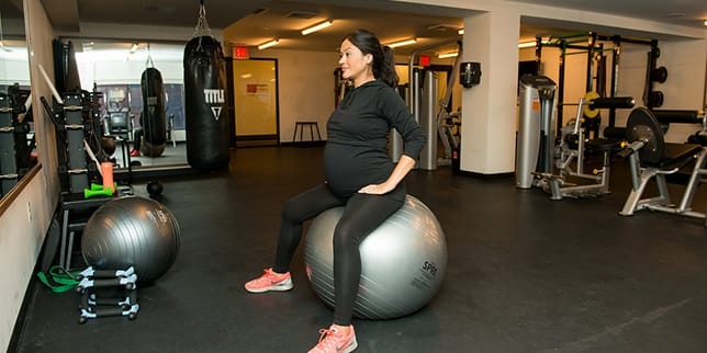 8 exercises to relieve hip pain during pregnancy pregnant woman on a yoga ball