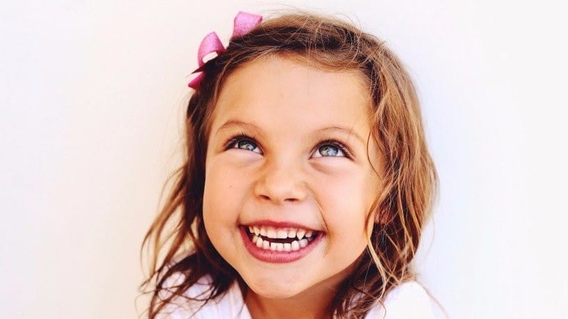 How to have happy kids—the Montessori way little girl smiling - how to raise a happy child