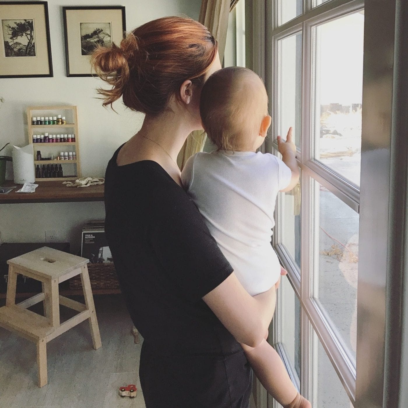 To the new mother who desperately misses her friends mom holding baby up to a window