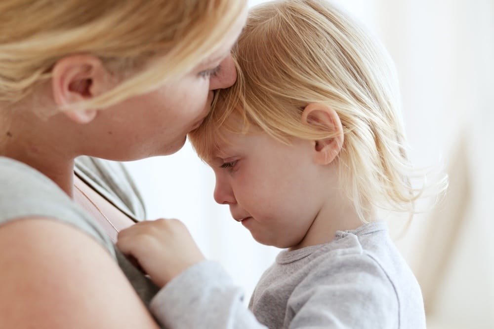You don’t have to ‘fix’ a crying child mom kissing daughter on head