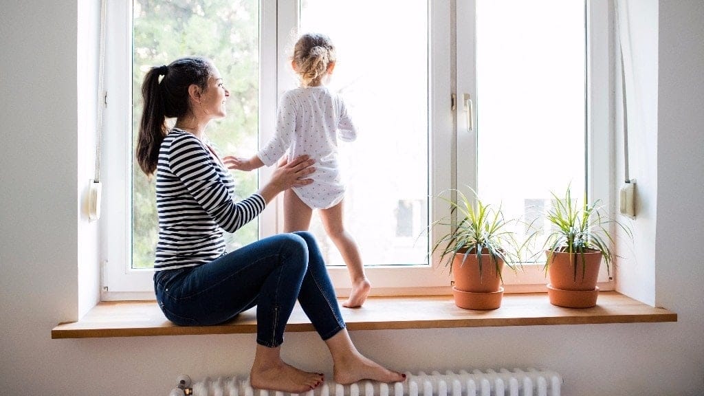 The simple yet powerful way to get your kids to cooperate mom watching daughter play near a window