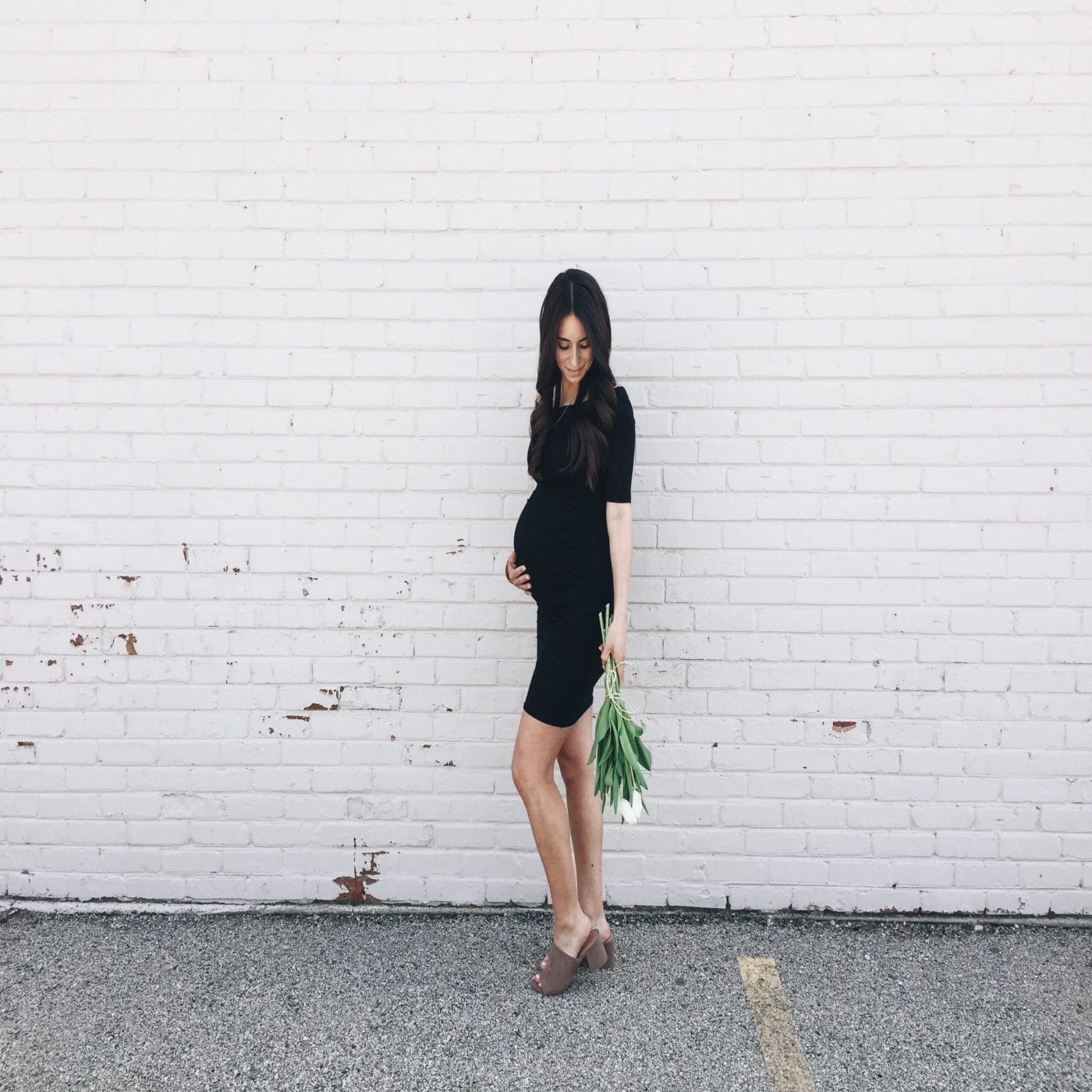 It’s Science: Your baby will always be a part of you pregnant woman holding belly in front of a brick wall