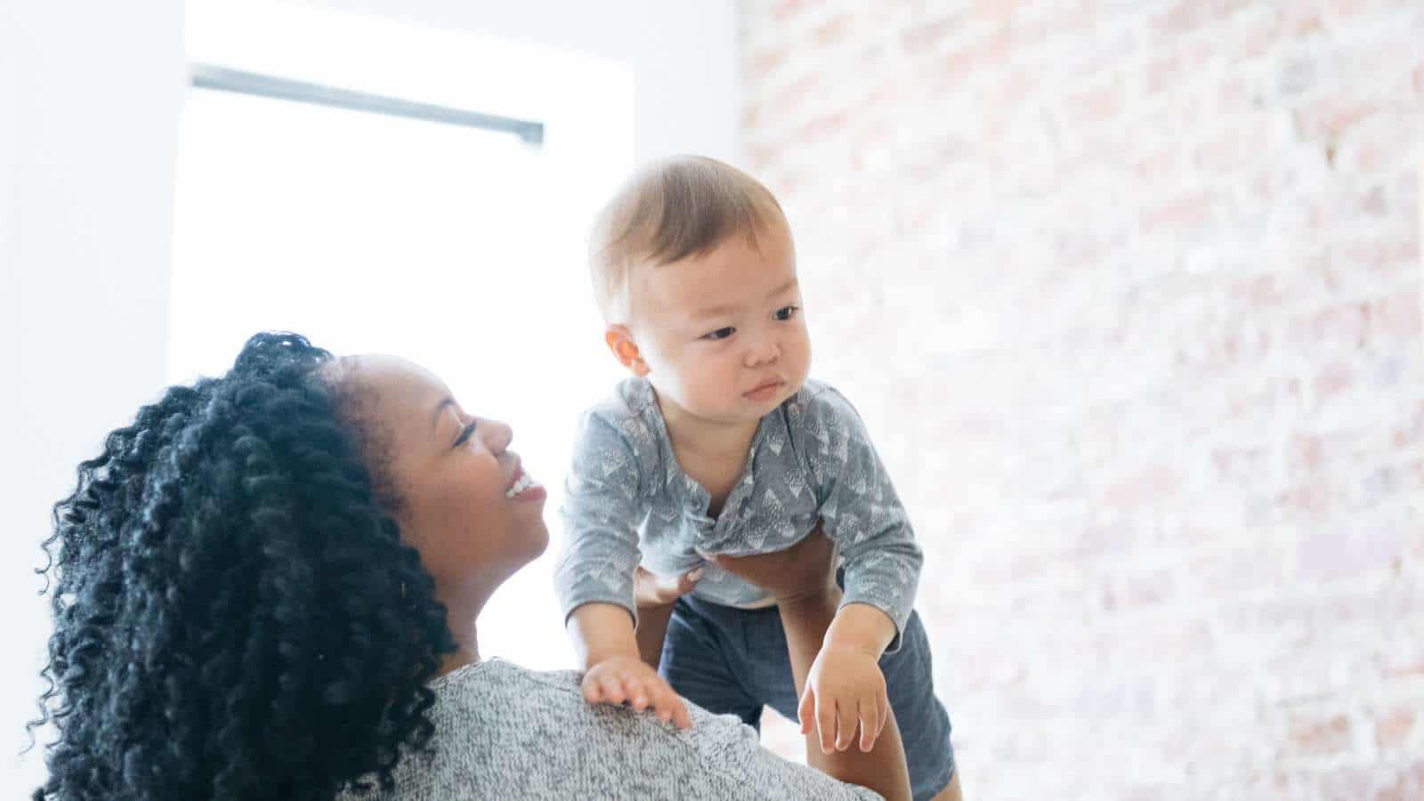 7 phrases not to say to a foster parent—and why woman lifting up a baby