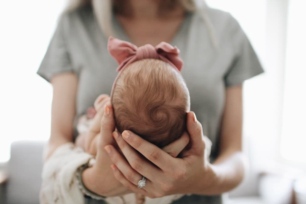 Dear first-time mama: You don’t have anything to prove mom holding newborn baby in front of her