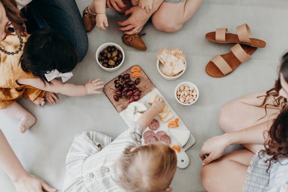 11 ways to help your child overcome picky eating & develop healthy habits family eating a picnic on a blanket