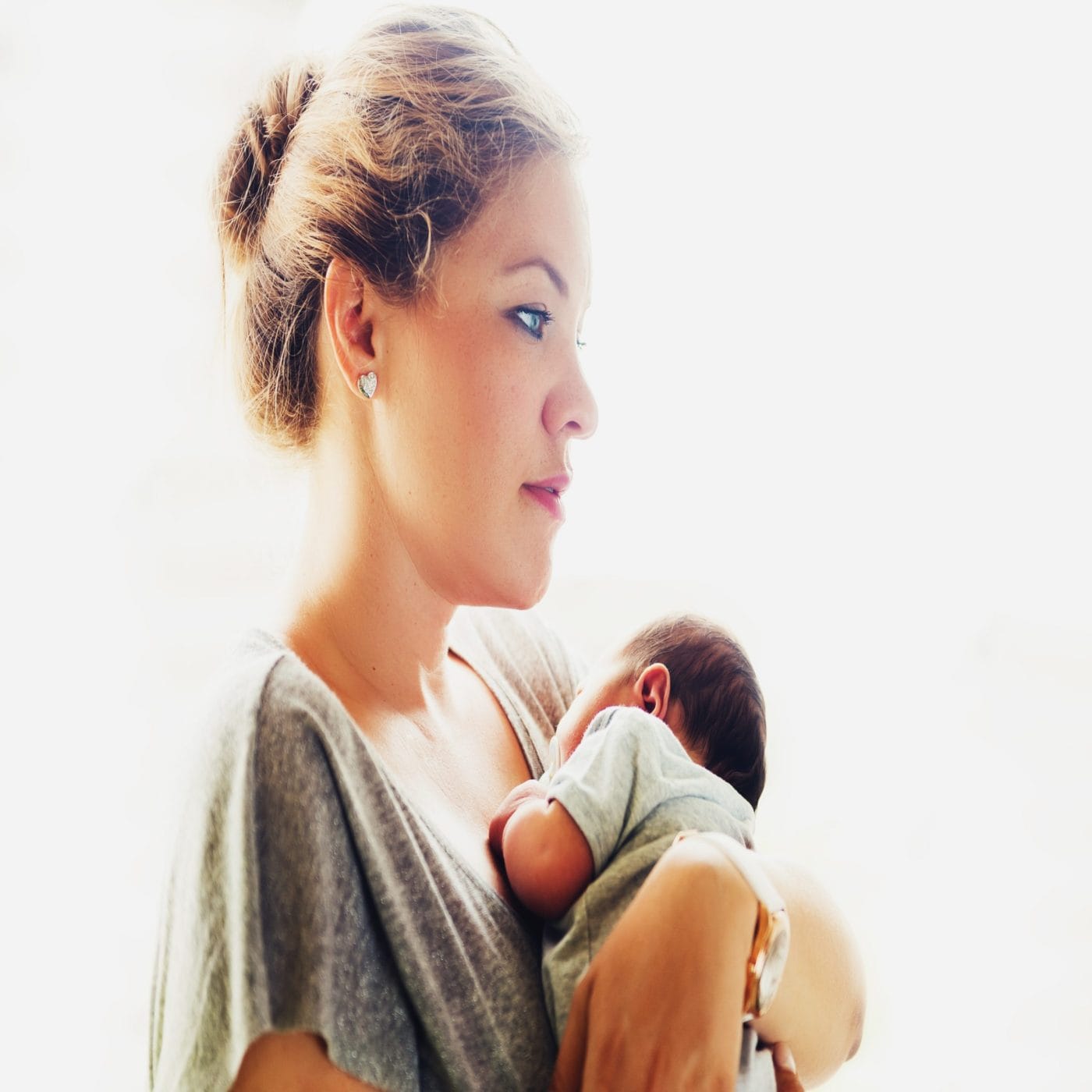 Here’s why becoming a mother for the first time is so physically intense mom holding newborn baby against her chest