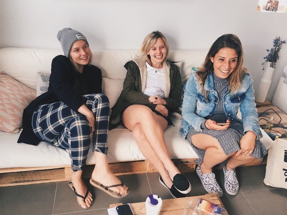 Motherhood helped me learn who my real friends are friends sitting on a couch and laughing