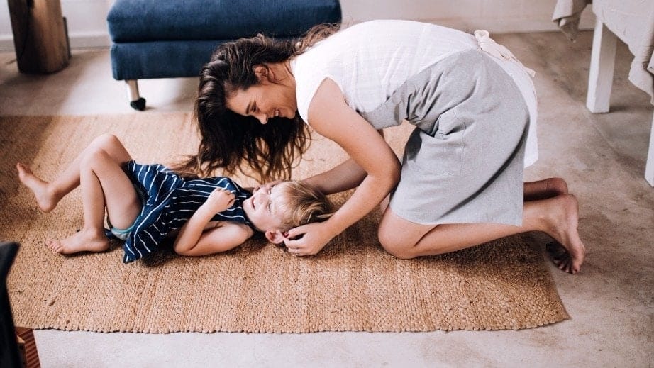 Working makes me a better mother—and motherhood makes me a better worker mom playing with child on the floor