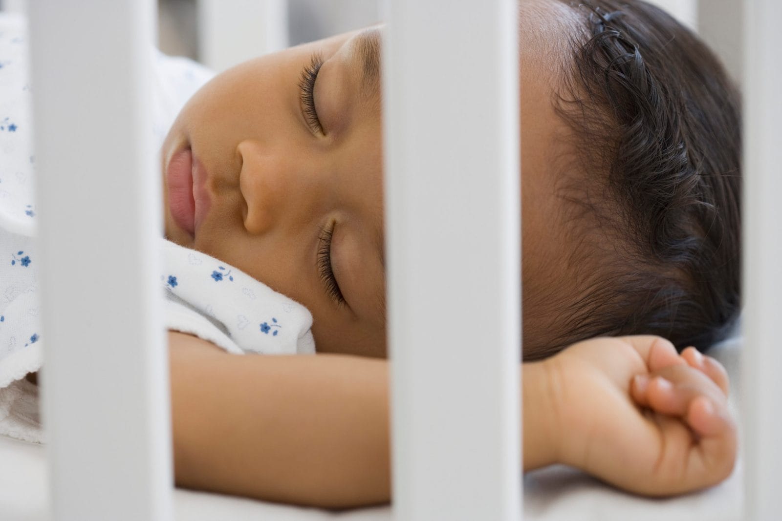 5 key tips for helping your baby with reflux sleep better baby sleeping in a crib