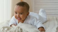 It’s science: Wanting to ‘eat’ your baby makes you a better parent baby doing tummy time on a bed