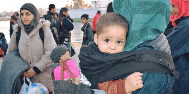 9 charities helping moms mom wearing baby in a carrier