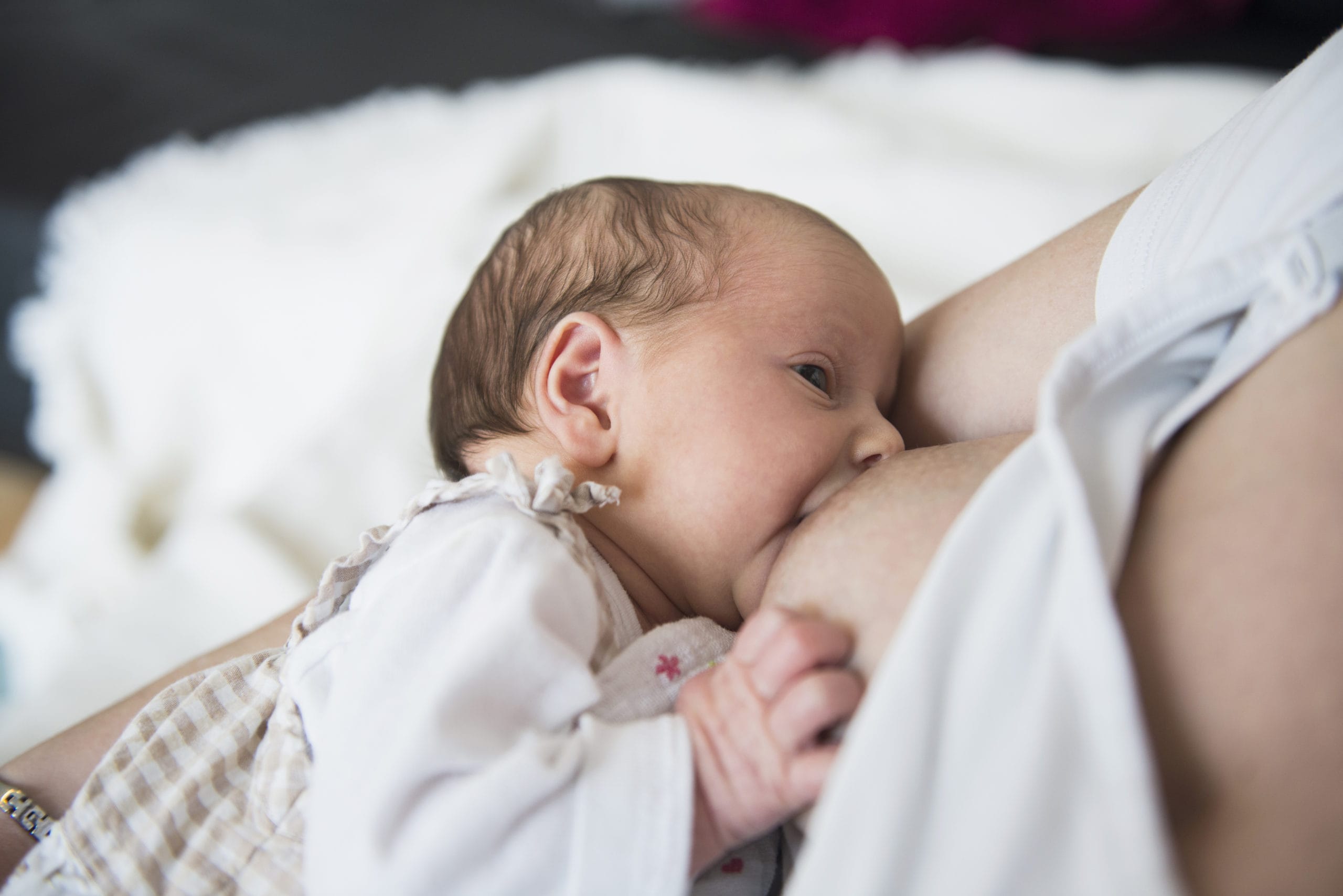 Not all breastfeeding babies with tongue-ties automatically need to get surgery, says new study a baby breastfeeding a woman