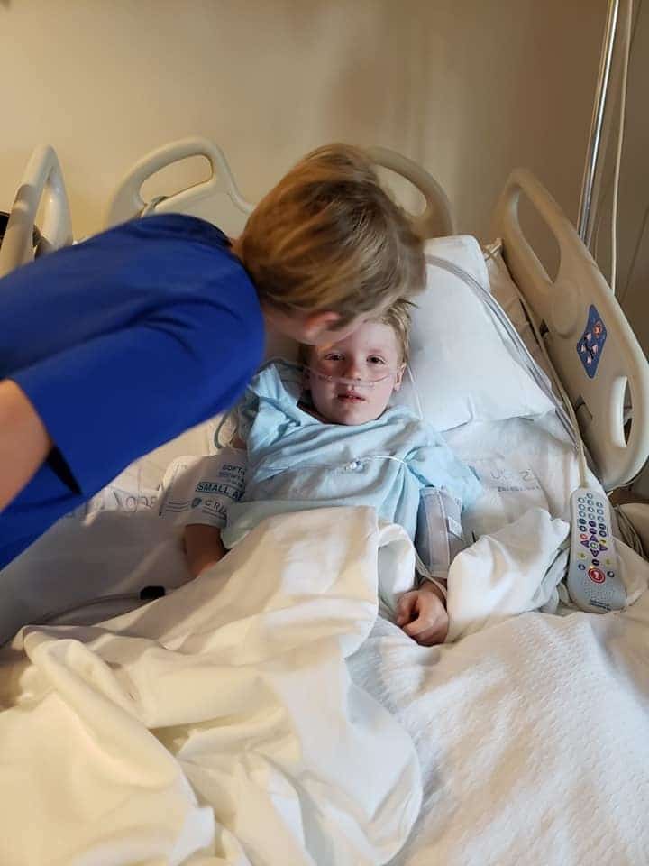 This mama’s gut-wrenching story of her son almost drowning has gone viral mom kissing son in a hospital bed on his head