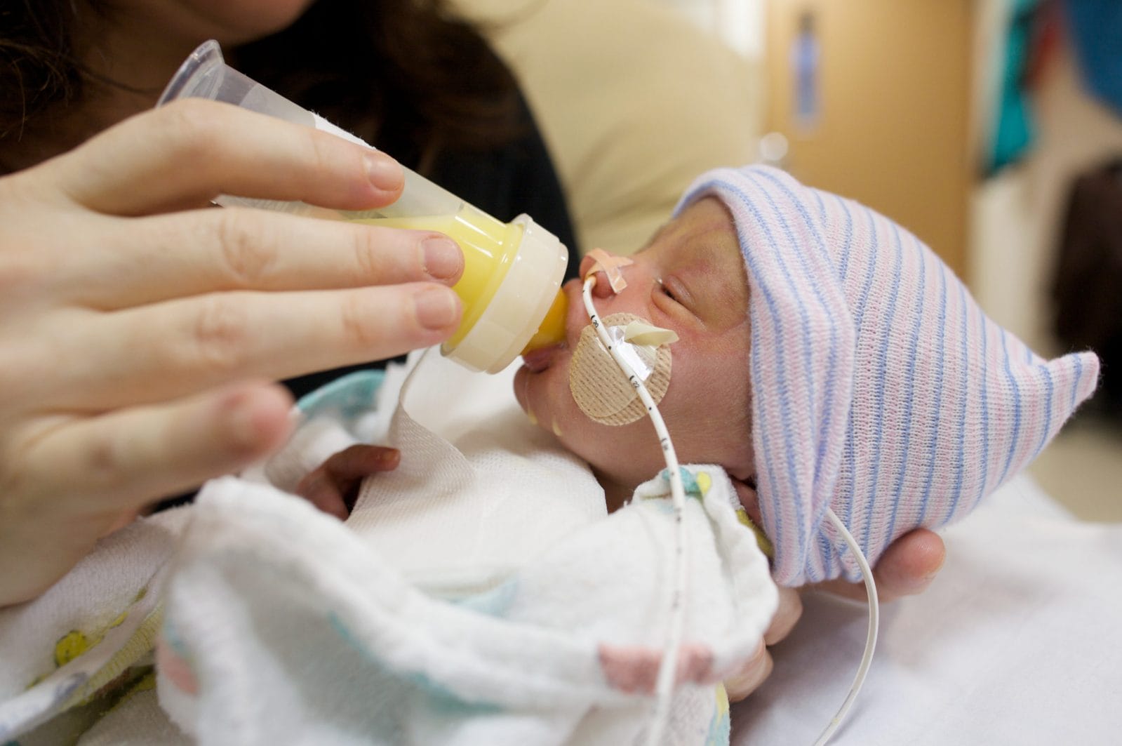 I learned about exclusively pumping after my preemie was born preemie baby being fed- exclusively pumping my preemie