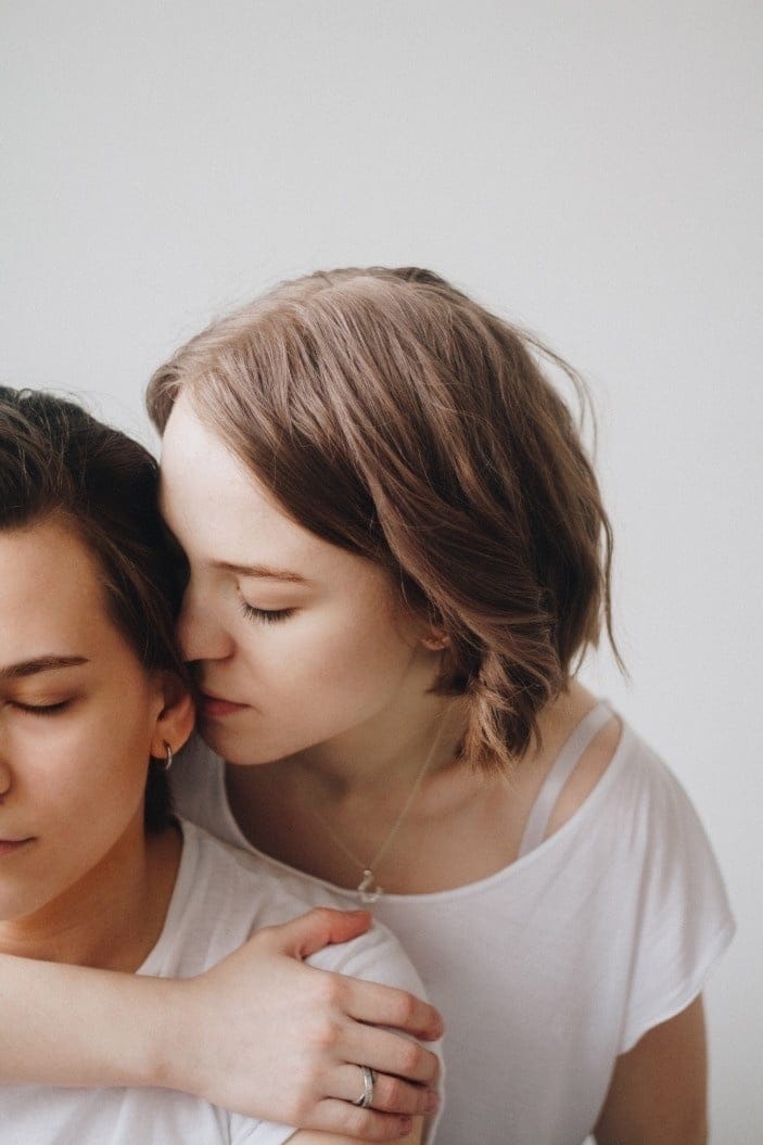 12 helpful phrases to talk about postpartum sex—whether you’re ready… or not woman snuggling into partners head