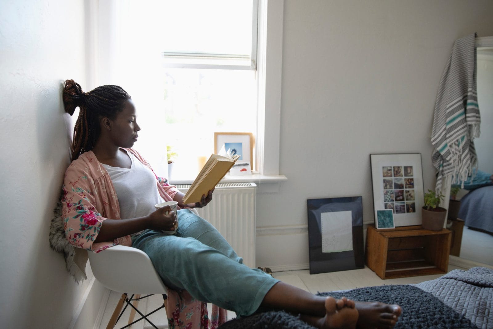It’s possible to thrive in parenthood as an introvert—here’s how introvert parent sitting by herself and reading