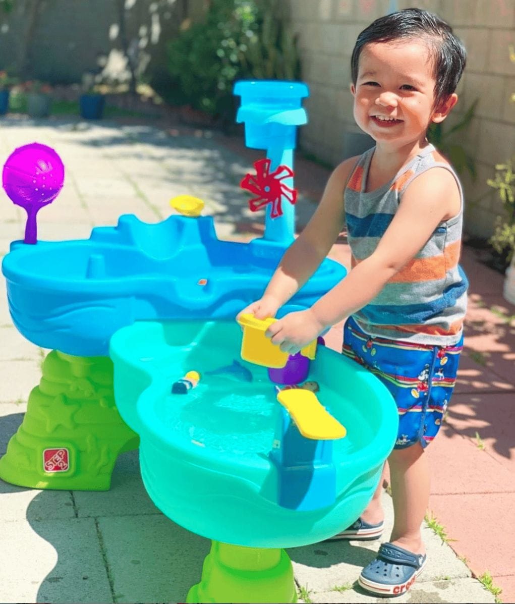 The best outdoor activities to keep your kids entertained all summer long little boy playing with a water table
