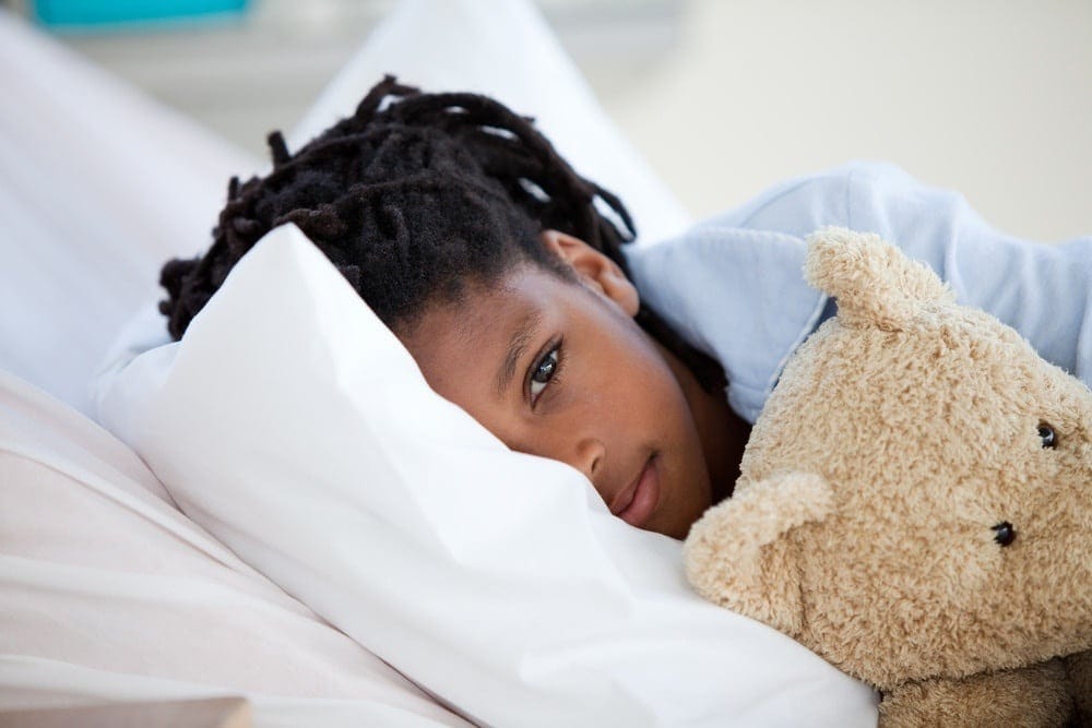 How sick is too sick to go to school? little girl sick in bed