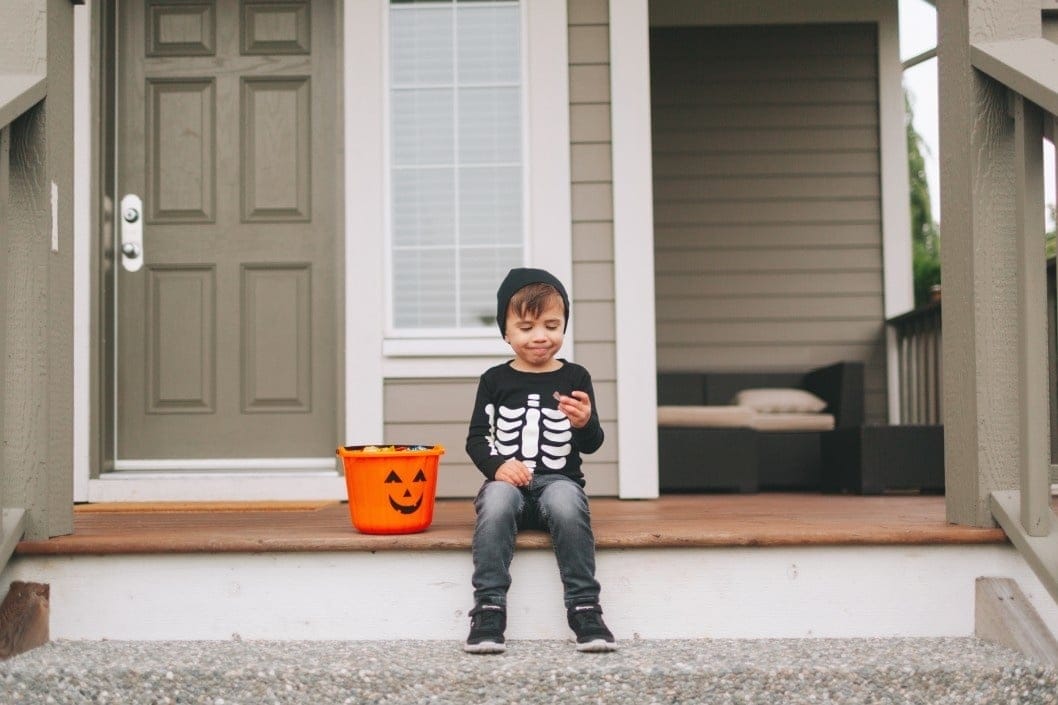 Why you should just let your kids eat their Halloween candy little boy dressed up for Halloween eating candy