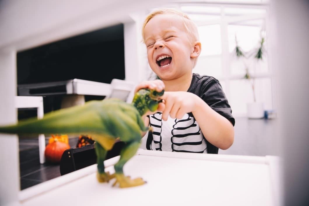 It’s science: Your toddler’s dinosaur obsession is making them smarter little boy playing with toy dinosaur