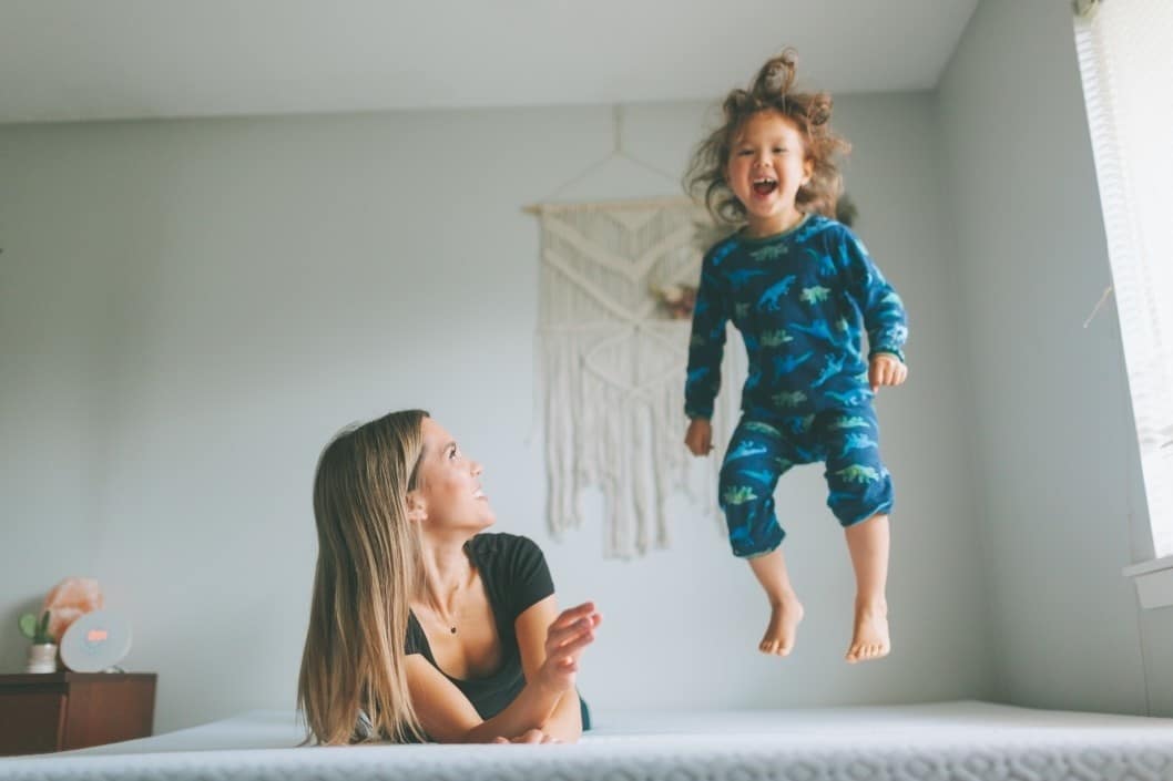 My child brought the magic back to my life mom watching toddler jump on the bed