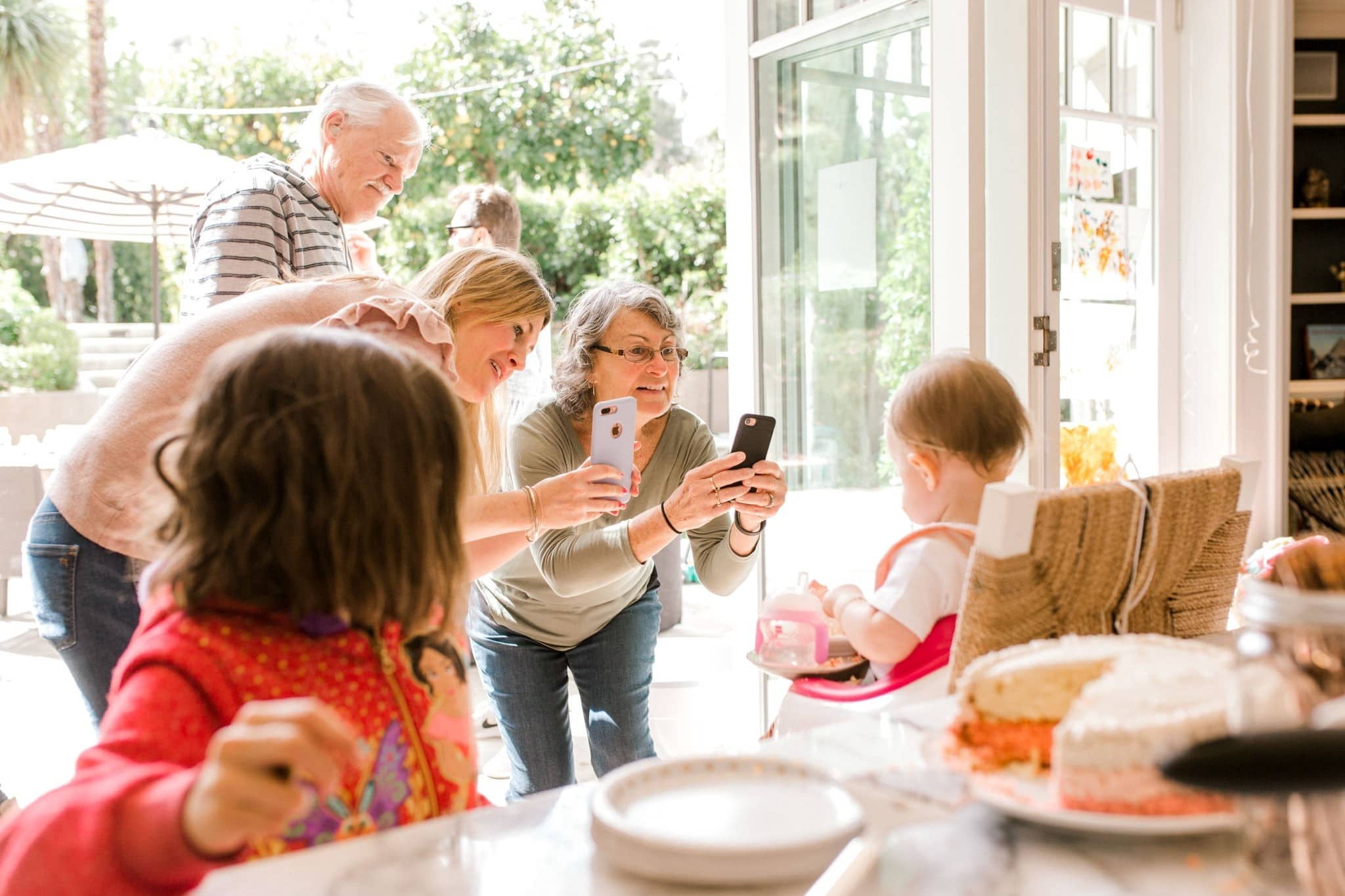 What’s the harm in posting about our kids on social media? family taking pictures on their phone of a child