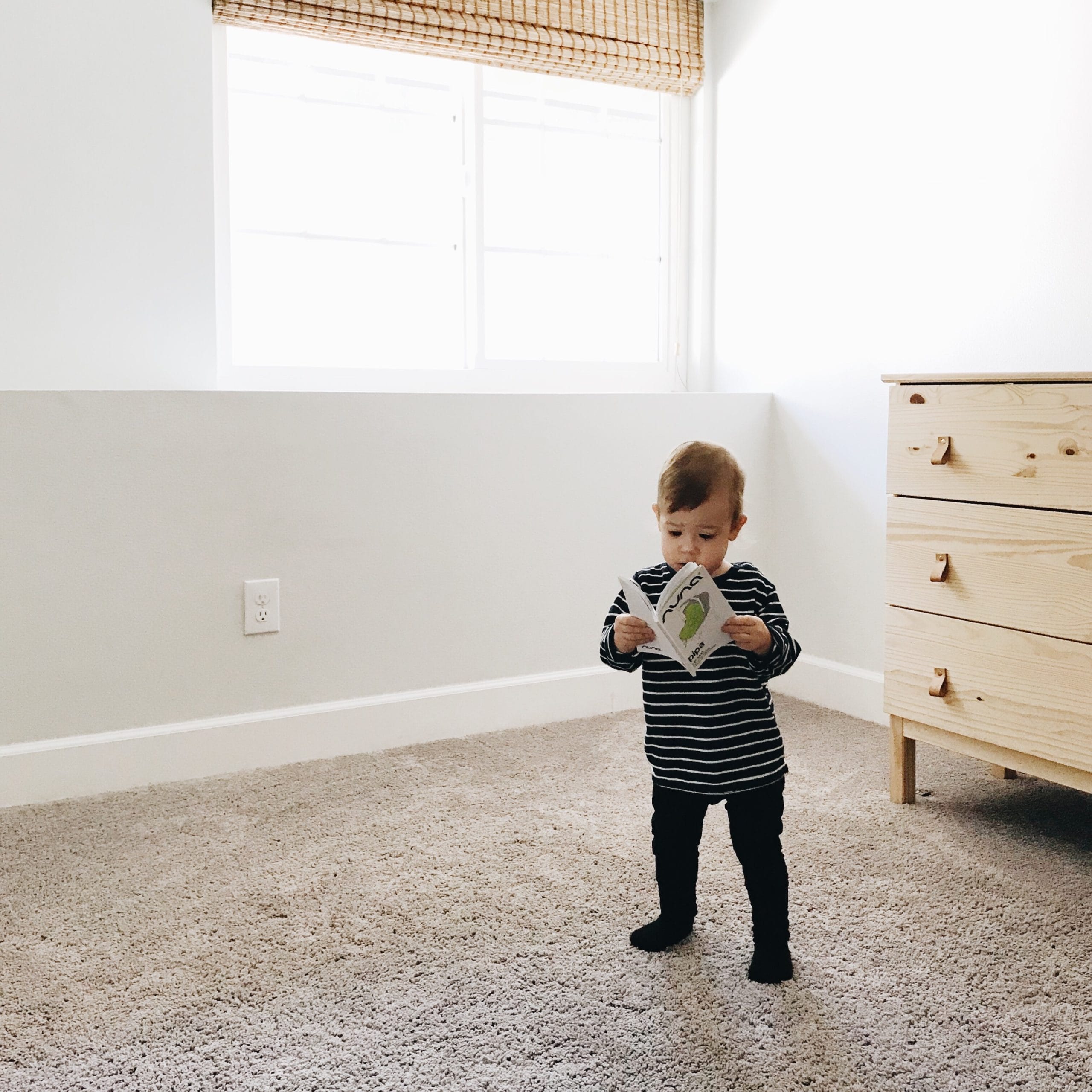 Montessori at home: 10 literacy activities to help you raise a lifelong reader little boy standing with a book