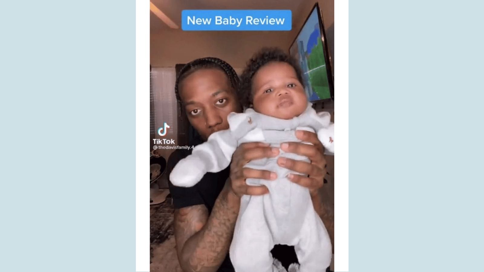 This dad is going viral for his hilariously honest ‘new baby’ review dad holding up newborn baby