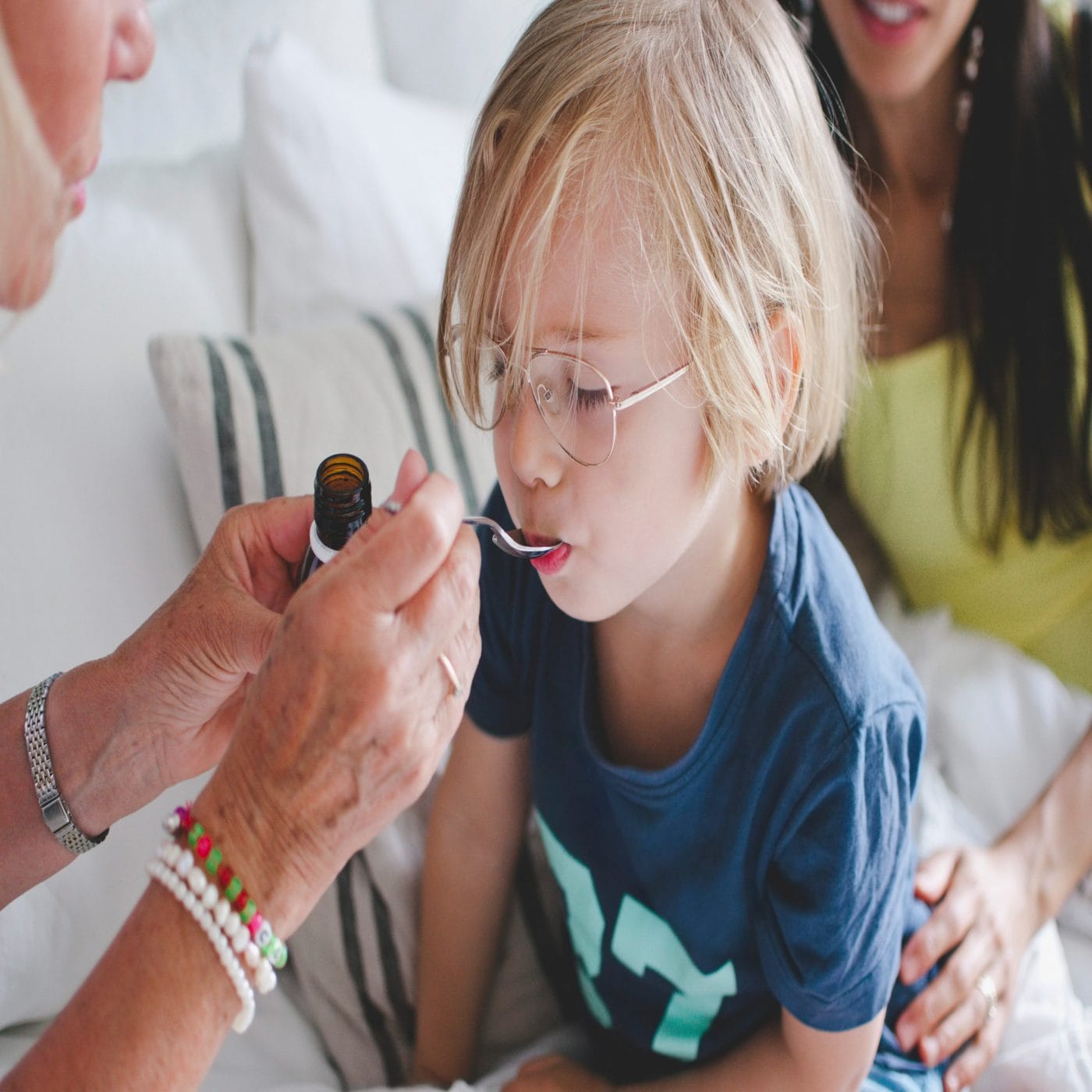 This year’s flu is setting hospital records: What parents need to know child taking medicine